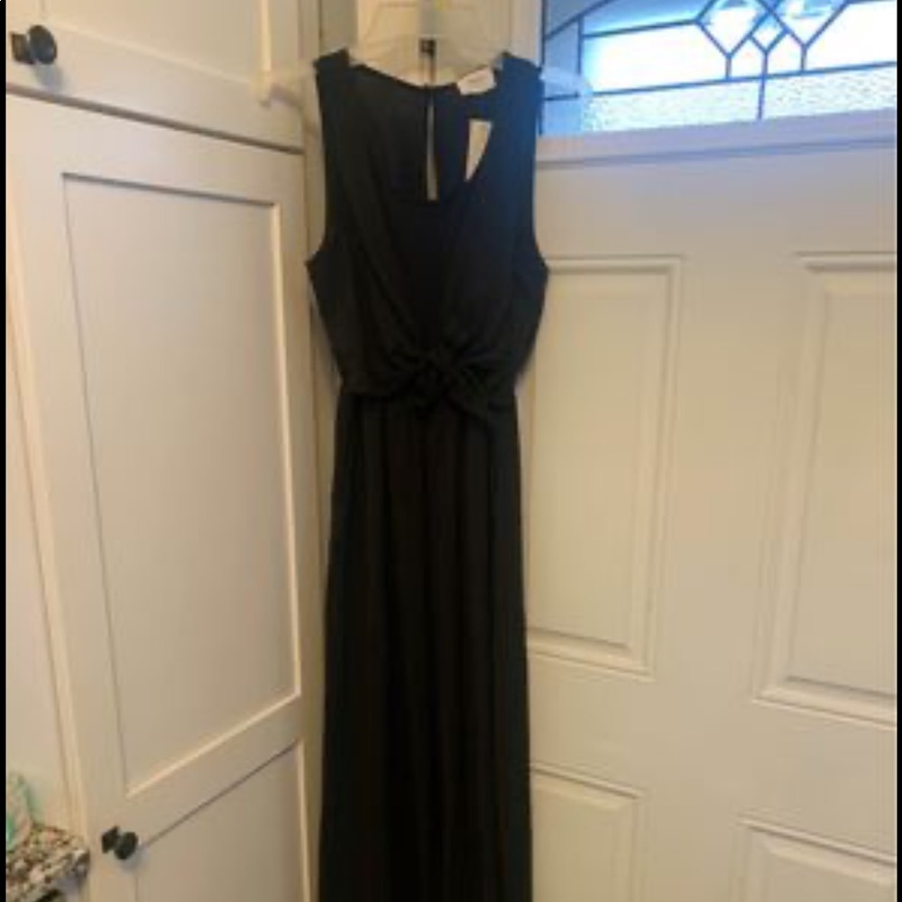 Super cute black jumpsuit with cute bow detail in the waistline and pockets